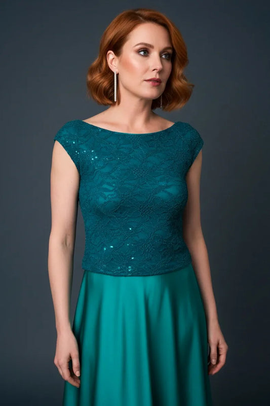 Woman wearing a teal shimmering tango top against a dark background, front view.