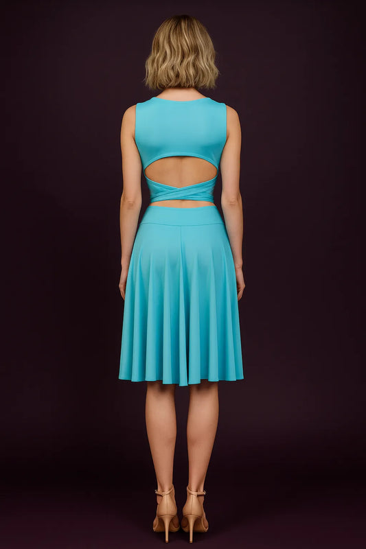 Woman wearing a turquoise tango skirt with cut-out design on a dark background, back view