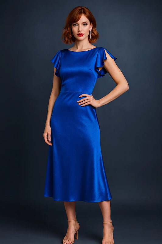 Woman wearing a blue velvet tango dress against a dark background, front view