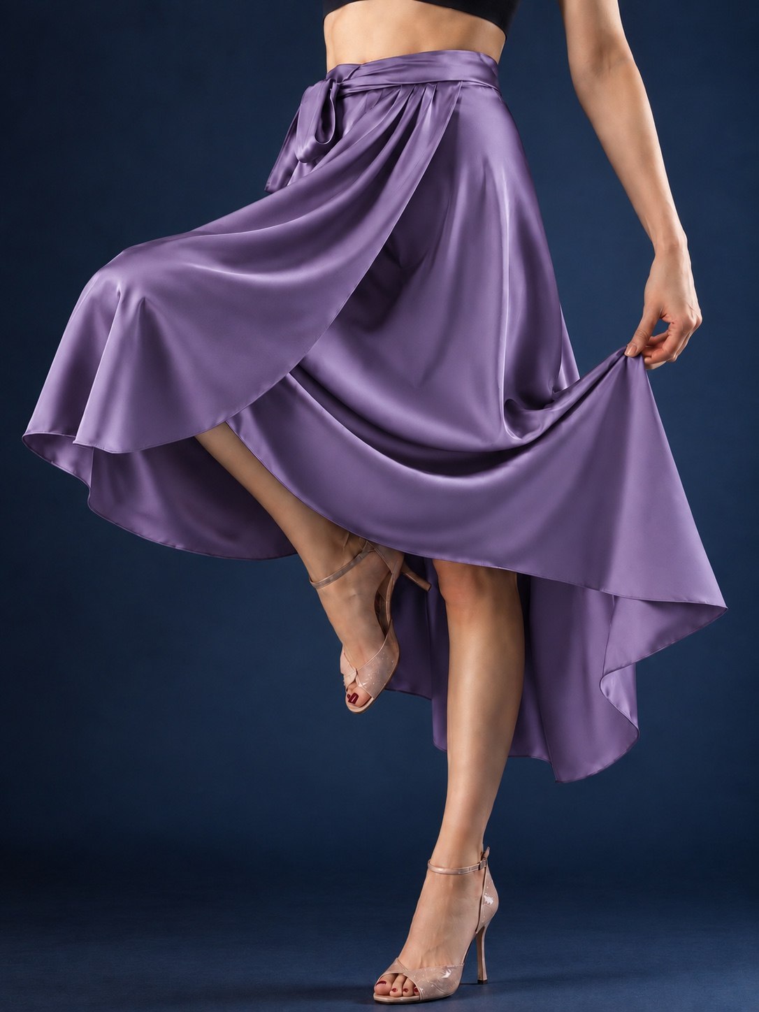 Front view of a women’s tango wrap skirt in flowing satin with a wide waistband, tie closure and asymmetric hem, designed for graceful movement in Argentine tango.