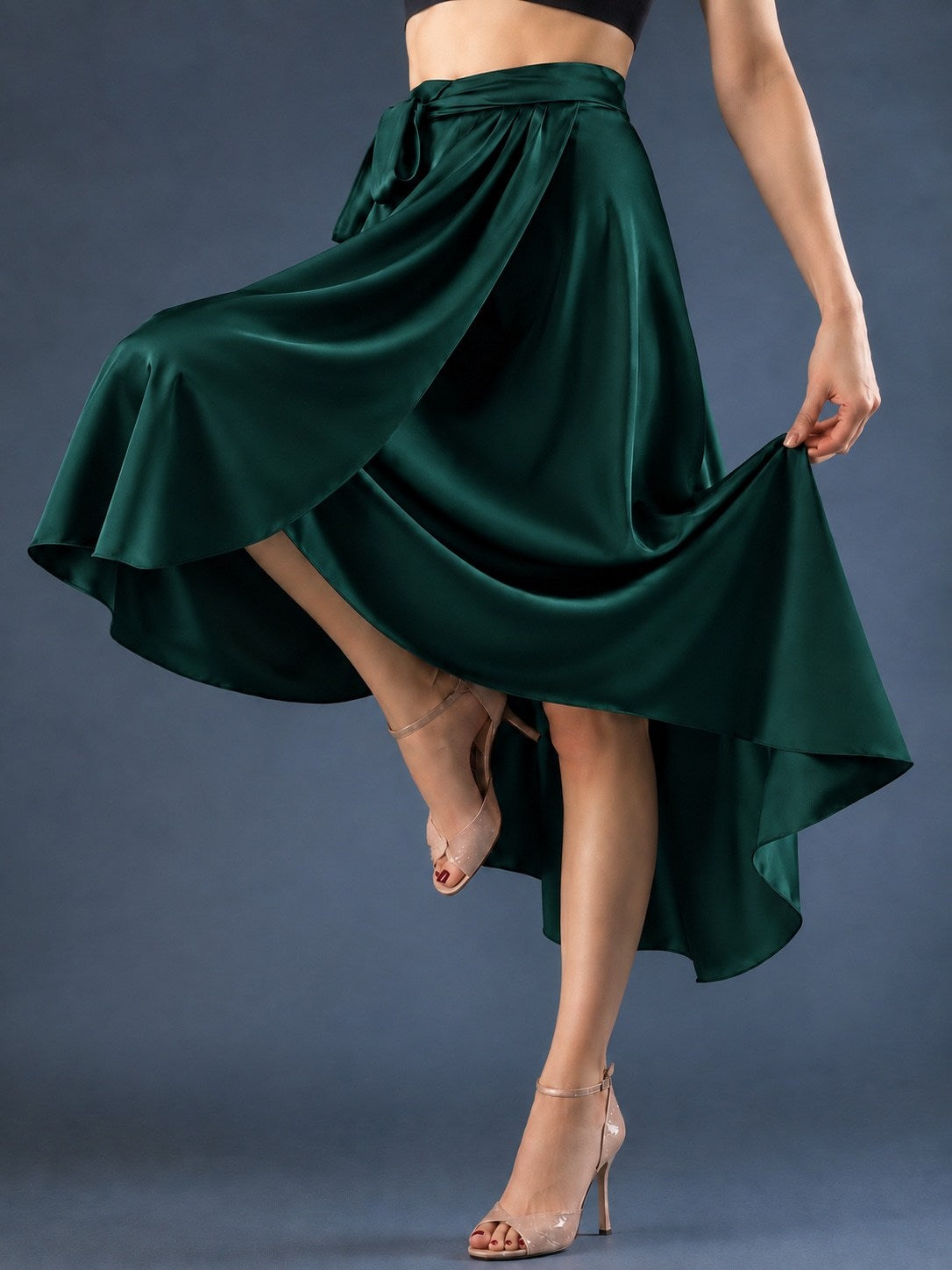 Front view of a women’s tango wrap skirt in flowing satin with a wide waistband, tie closure and asymmetric hem, designed for graceful movement in Argentine tango.