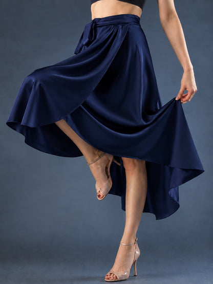 Front view of a women’s tango wrap skirt in flowing satin with a wide waistband, tie closure and asymmetric hem, designed for graceful movement in Argentine tango.