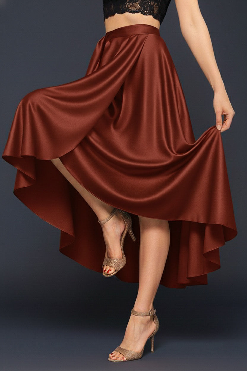 Wrap brown skirt being twirled by a person on a dark background