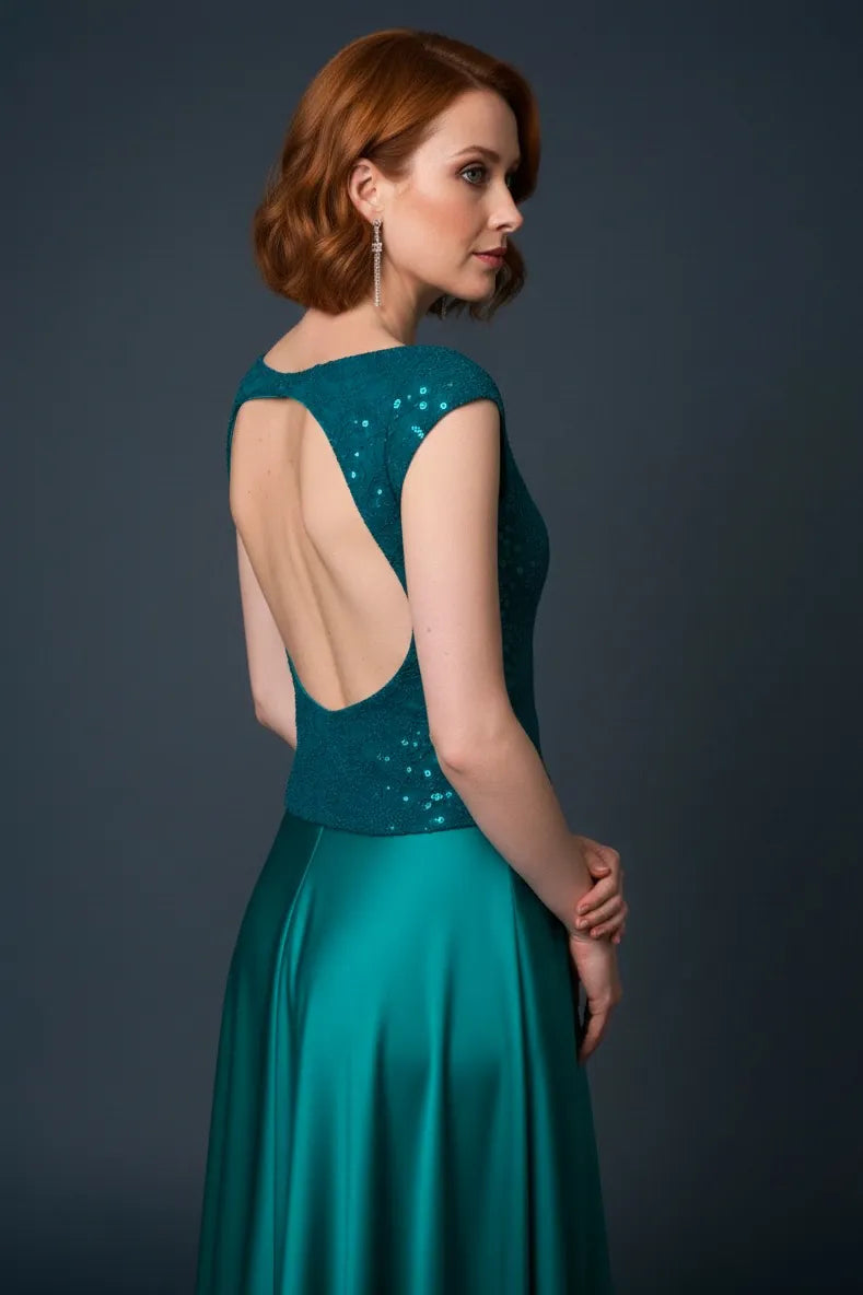 Woman wearing a teal shimmering tango top with an open back, back view.