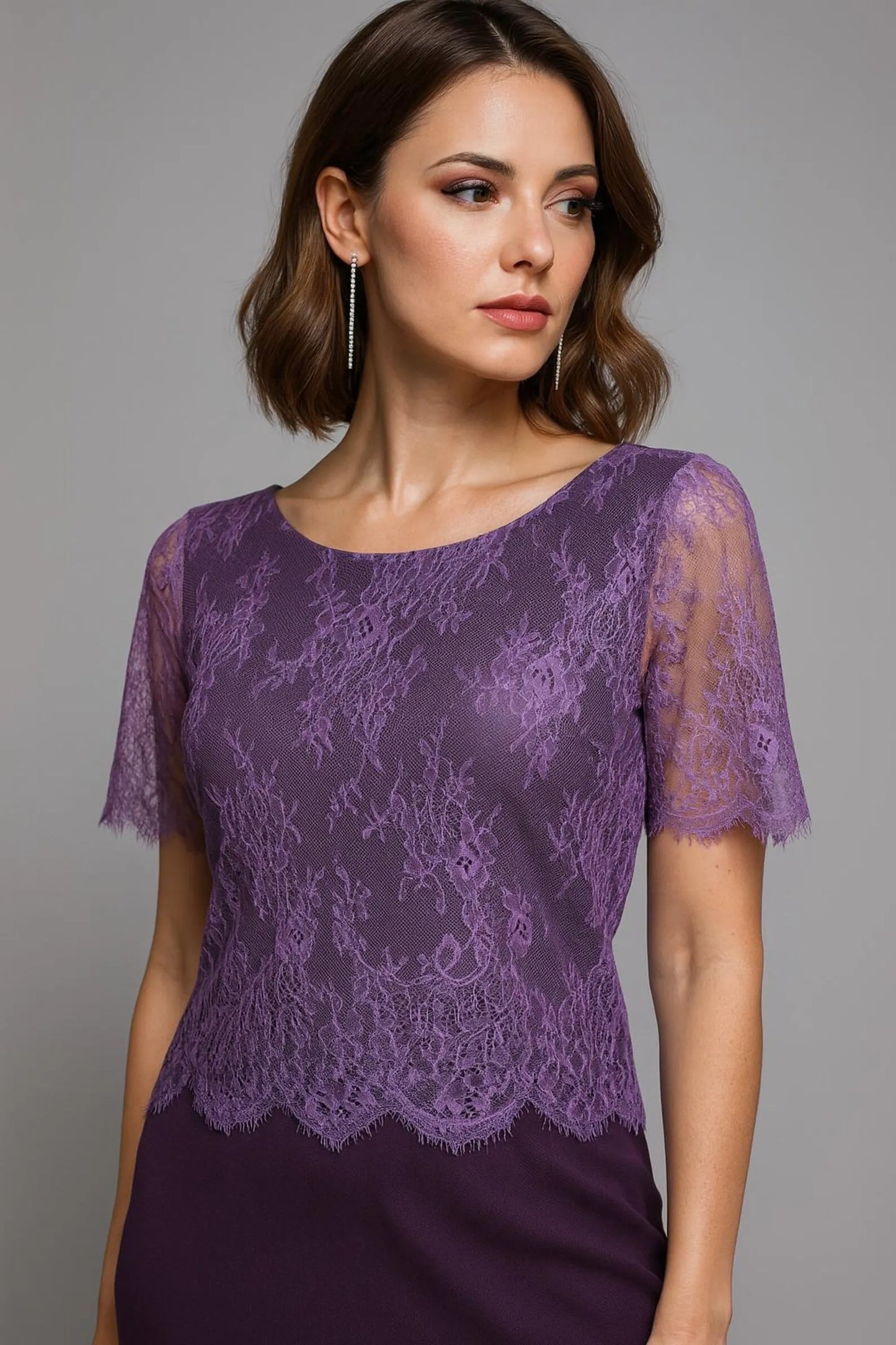 Woman wearing a purple lace tango top against a gray background