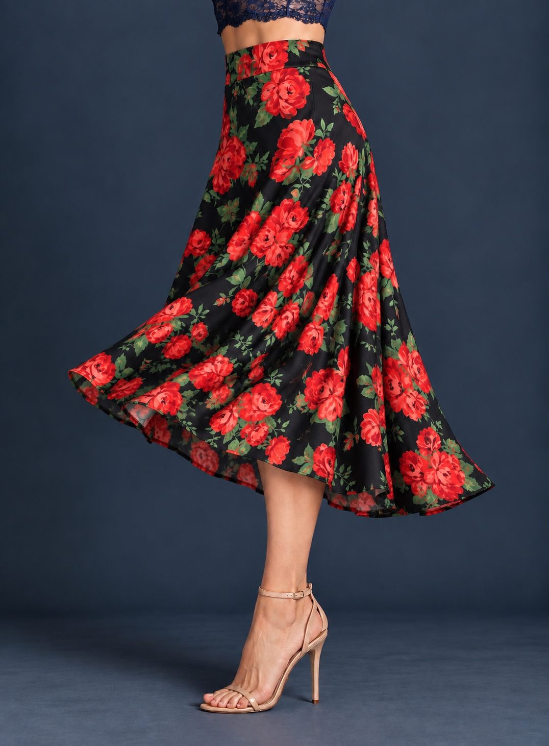 Women’s silky jersey tango skirt with red rose floral print, wide waistband, and full A-line silhouette flowing outward in movement.
