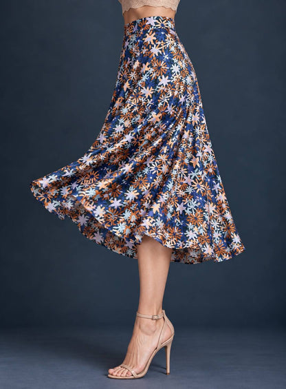 Women’s silky jersey tango skirt with a small multicolor floral print and full A-line silhouette flowing outward in movement.