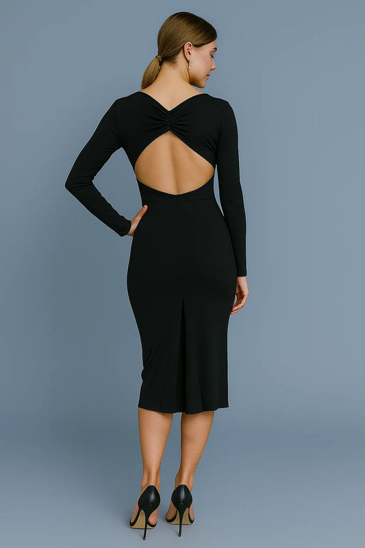 Woman wearing a black tango dress with an open back against a gray background