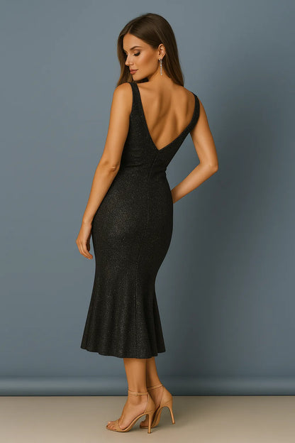 Woman wearing a black tango dress with a deep back