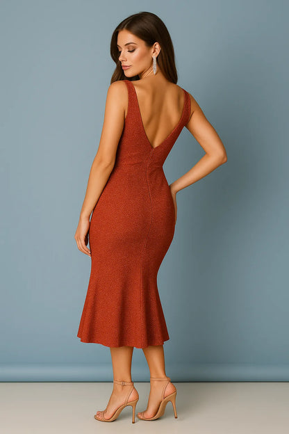 Woman wearing a rust-colored shining tango dress with a backless design