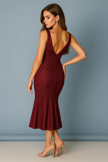 Woman wearing a burgundy tango dress with a backless design