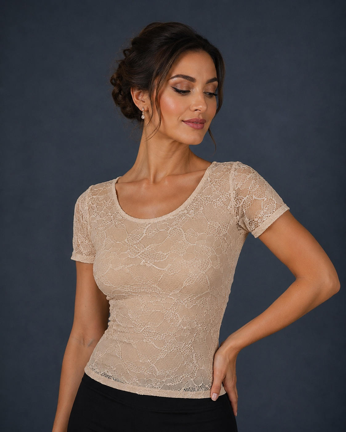 A woman wearing a beige lace short-sleeve scoop-neck top.