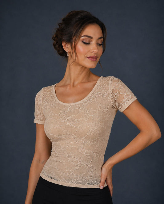 A woman wearing a beige lace short-sleeve scoop-neck top.
