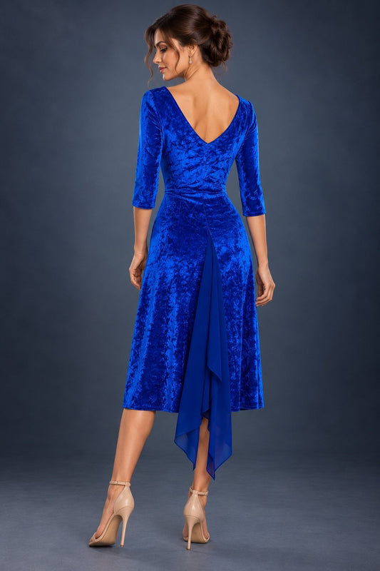 Back view of a royal blue marbled velvet tango dress with three-quarter sleeves and a back slit finished with flowing chiffon godets, designed for Argentine tango dancing.