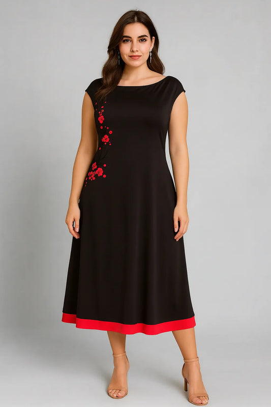 Woman wearing a black tango dress with red accents on a gray background