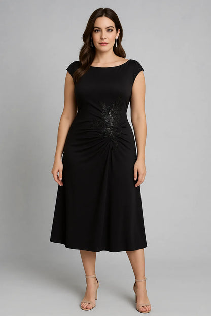 Woman wearing a black tango dress against a gray background