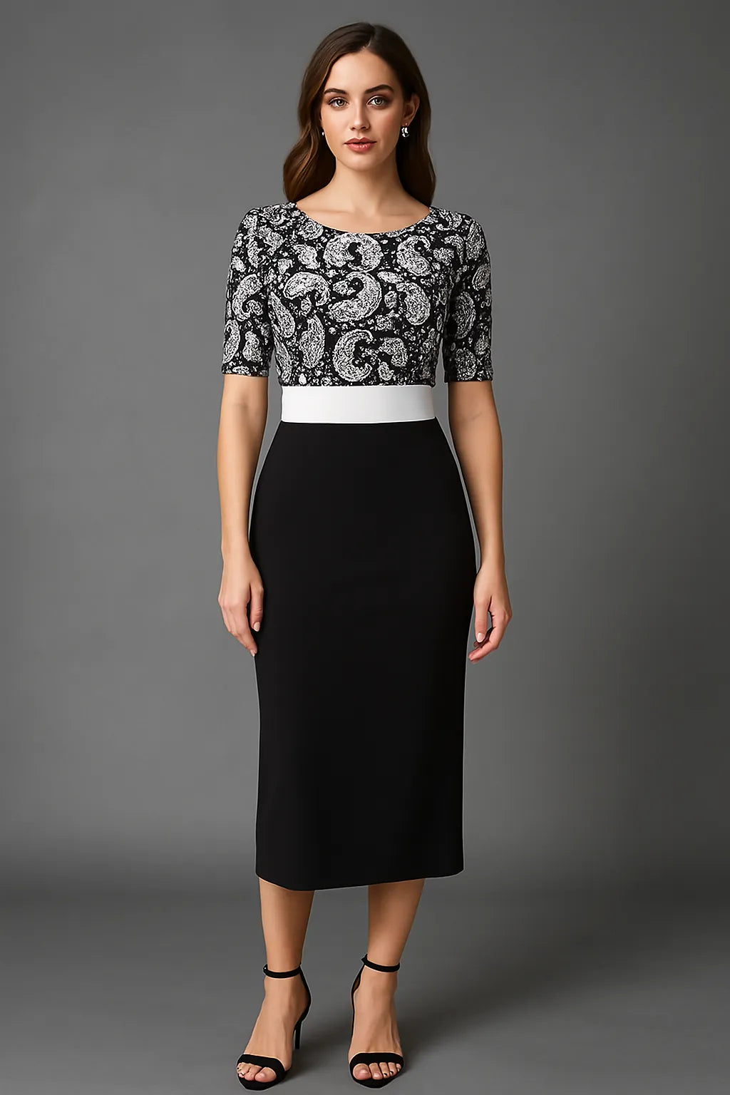 Woman wearing a black and white patterned top with a black pencil tango dress on a gray background