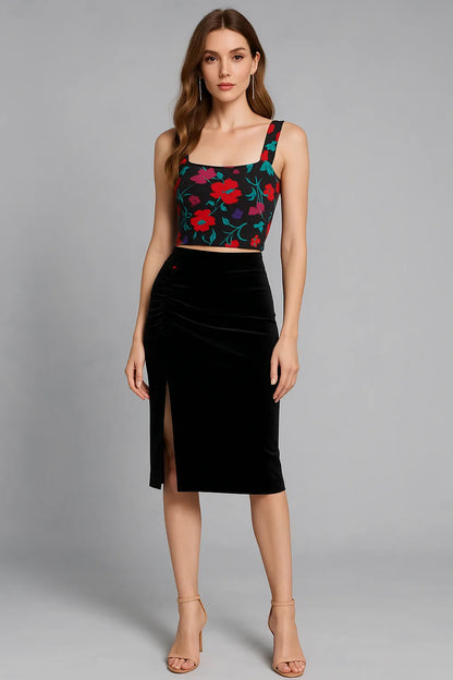 Woman wearing a floral tango top and black tango skirt on a gray background