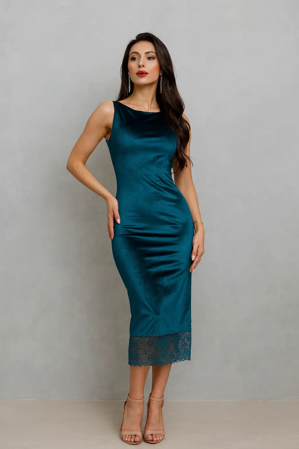 Woman wearing a teal tango dress with lace details on a plain background