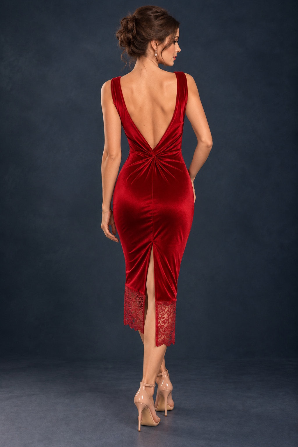 Back view of a fitted stretch velvet tango dress with a deep open back, decorative knot at the waist, central back slit and delicate lace hem.