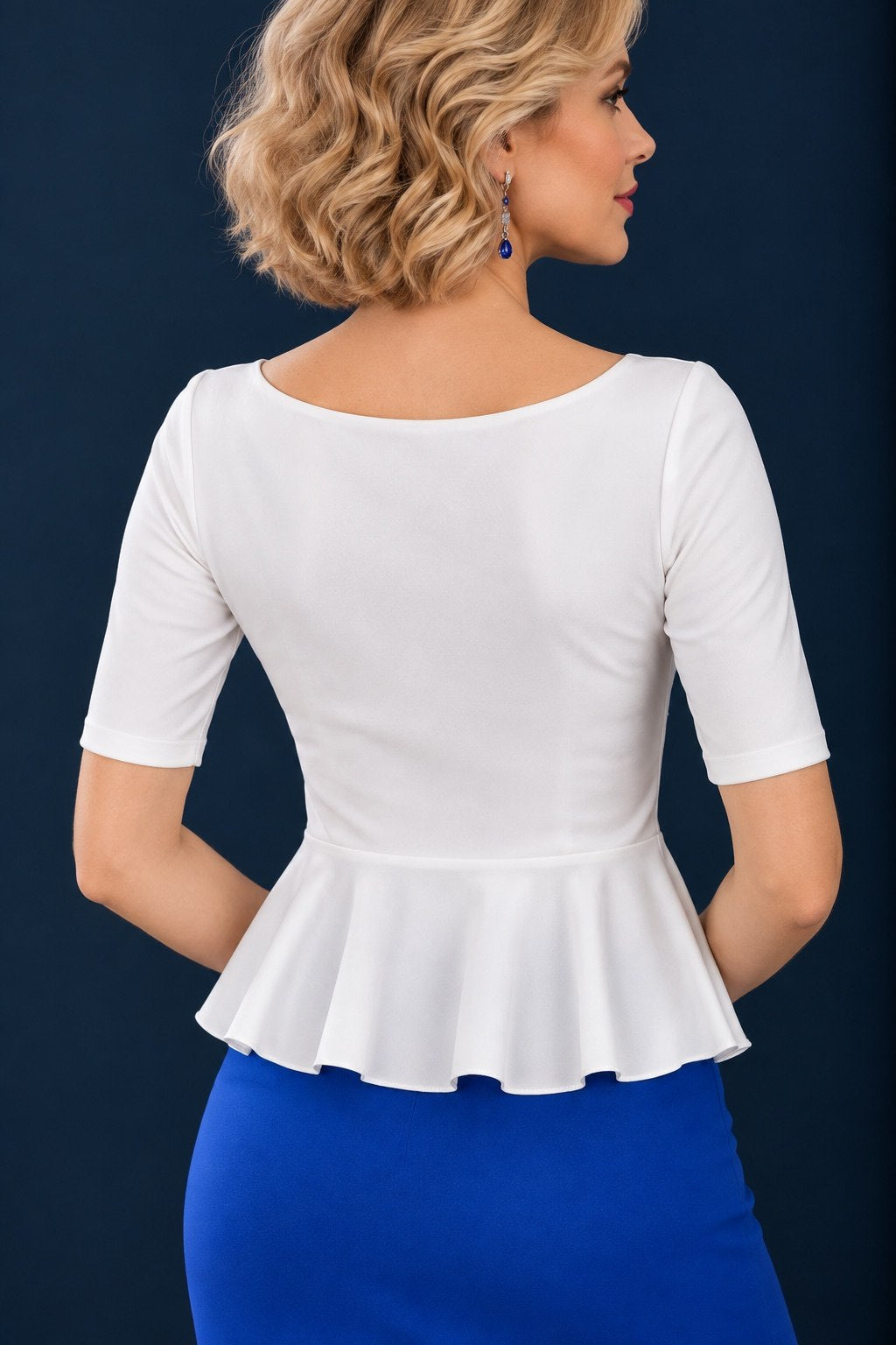 Back view of a white women’s tango top in silky stretch jersey with elbow-length sleeves, a wide rounded neckline and flowing peplum waist.