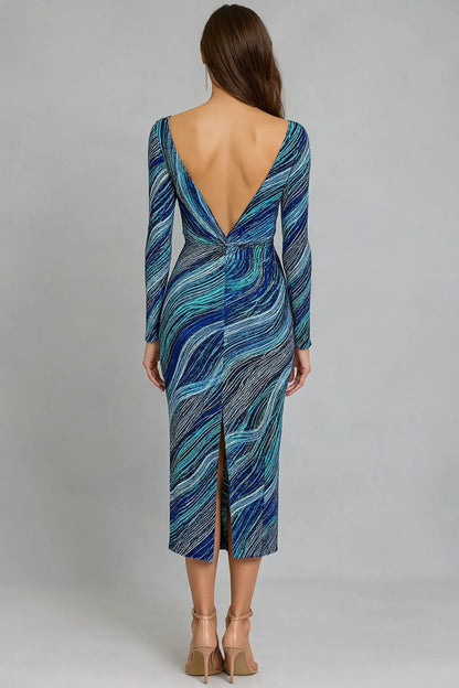 Woman wearing a blue patterned tango dress with a backless design on a gray background
