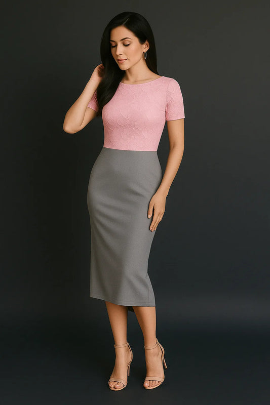 Woman wearing a pink top and gray tango dress against a black background