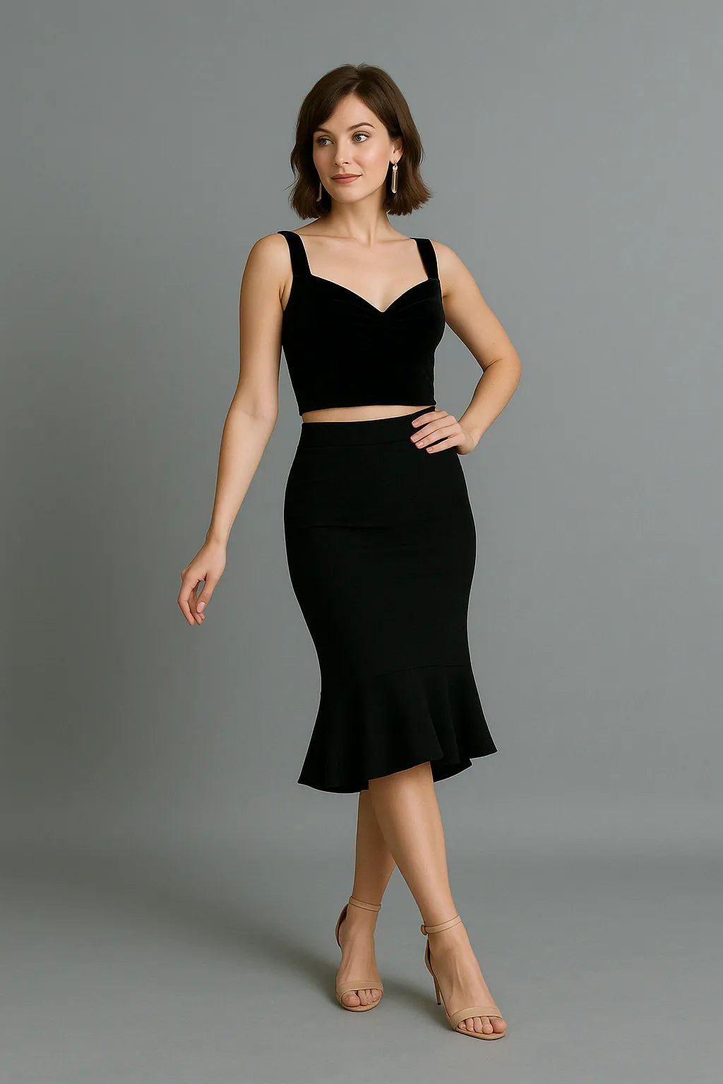 Woman wearing a black sleeveless tango top and black tango skirt on a gray background