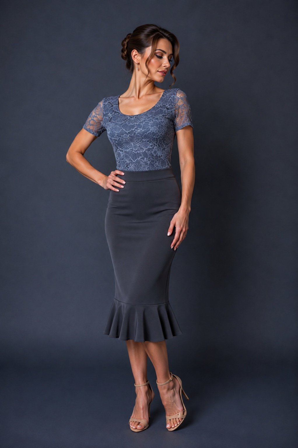 A woman modeling a two-piece dress with a blue lace short-sleeve top and a dark gray flared midi skirt, paired with beige high-heeled sandals, against a dark gray studio background.