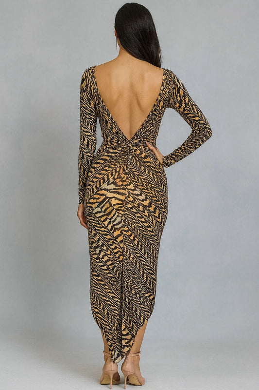 Woman wearing a long-sleeve, animal print tango dress with a backless design on a plain background.