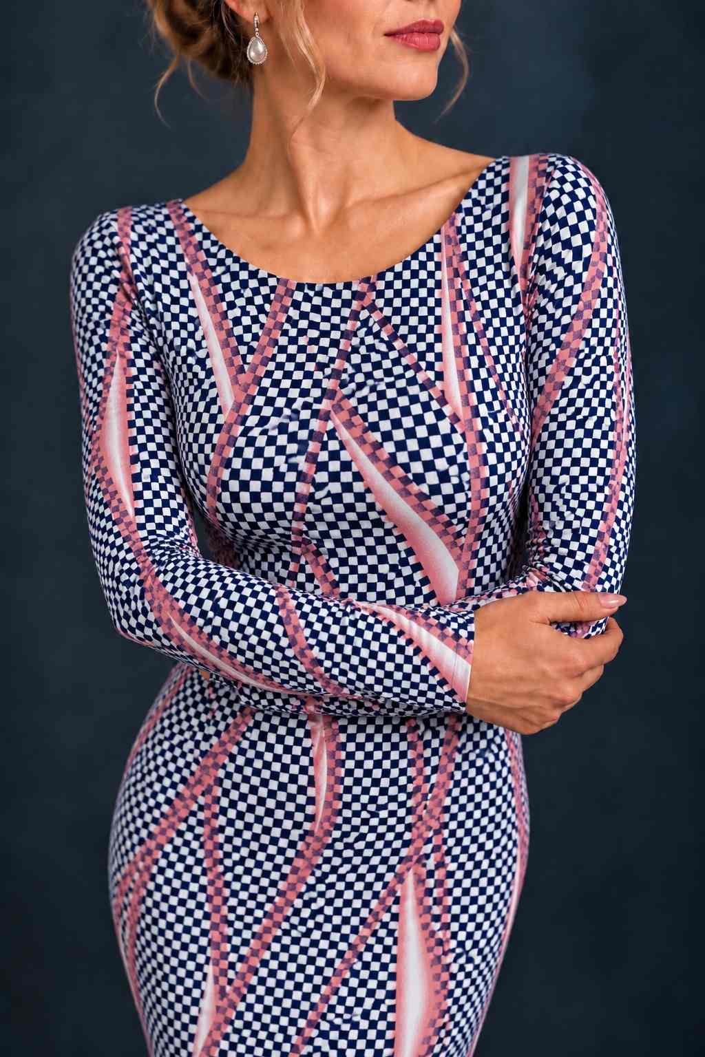 Front view of a women’s tango dress in silky textured stretch jersey with long sleeves, a fitted silhouette and asymmetric midi-length hem, designed for Argentine tango dancing.