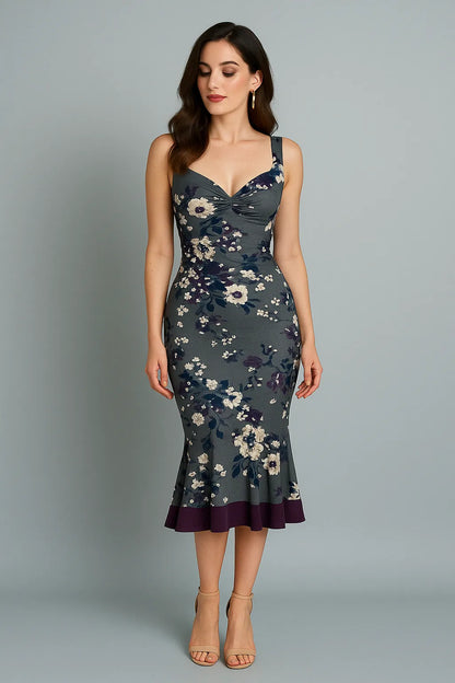 Woman wearing a floral tango dress against a gray background