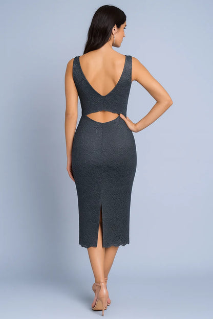 Woman wearing a gray tango dress with cut-out design on a plain background