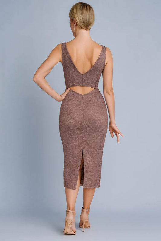 Woman wearing a brown tango dress with cut-out back on a gray background