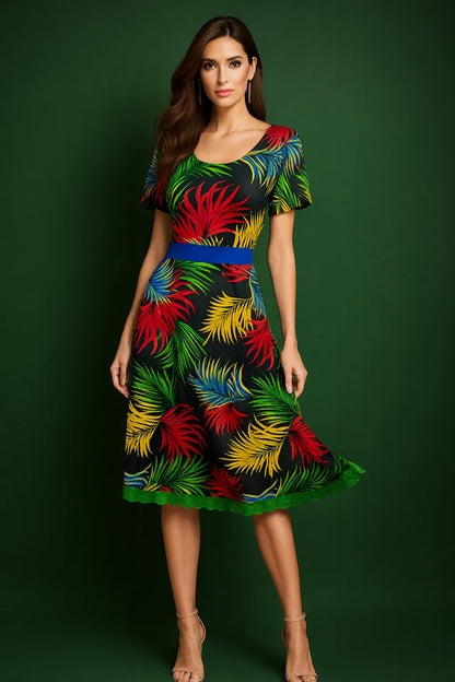 Woman wearing a colorful tango dress with a leaf pattern on a green background