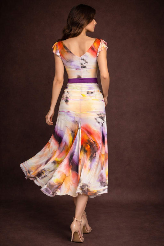 Woman wearing a colorful playful tango dress with a flowing skirt, back view