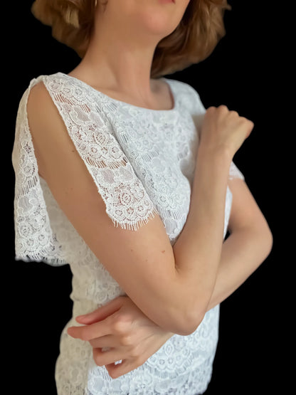Elegant lace top with delicate draped sleeves