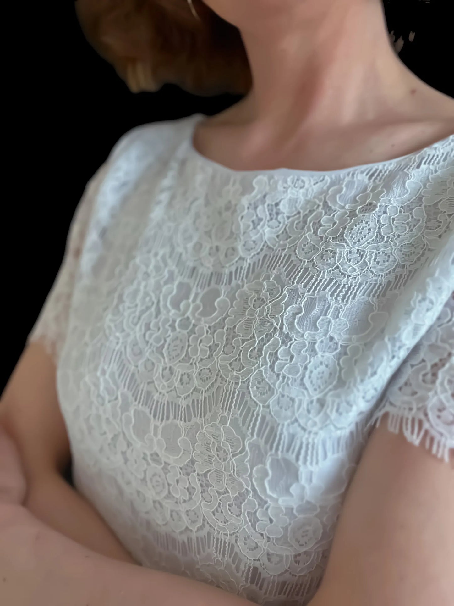 Elegant lace top with delicate draped sleeves