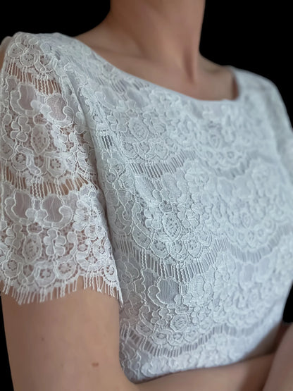 Elegant lace top with delicate draped sleeves