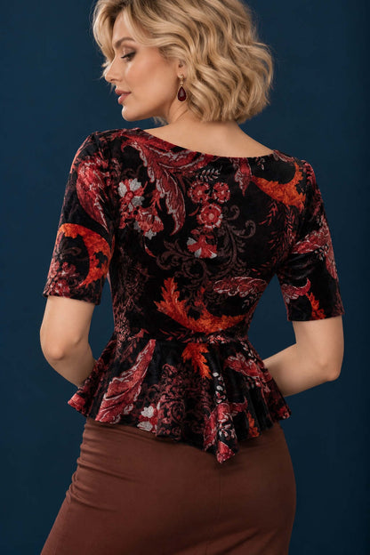 Back view of a patterned velvet tango top with elbow-length sleeves, fitted bodice and flowing peplum waist.