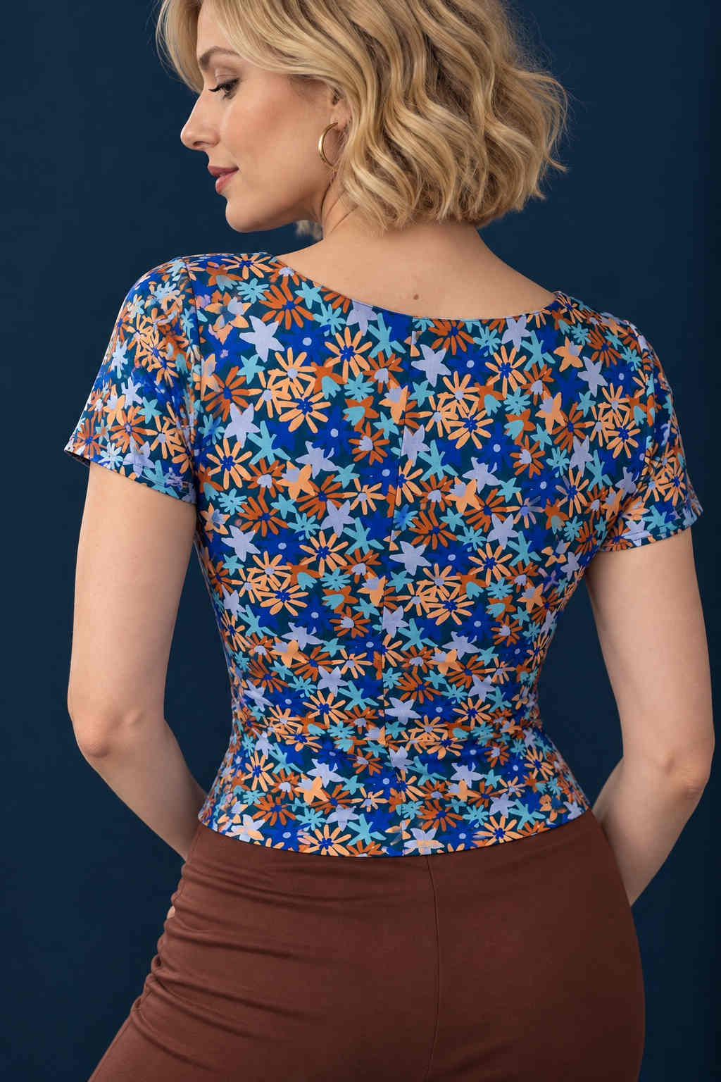 Back view of a colorful floral silky jersey tango top with short sleeves, rounded neckline and fitted silhouette.