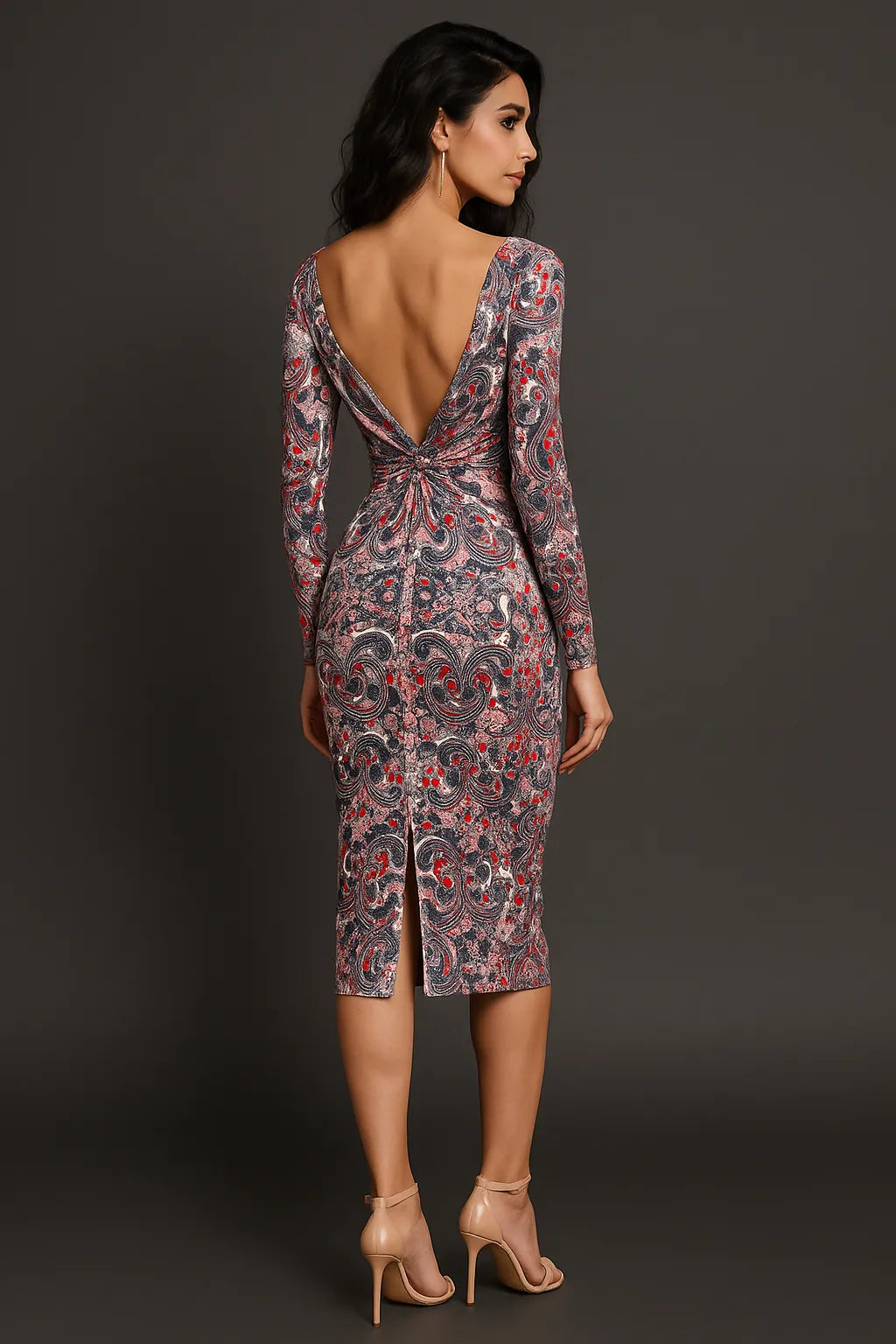 Woman wearing a patterned tango dress with a deep backless design on a dark background