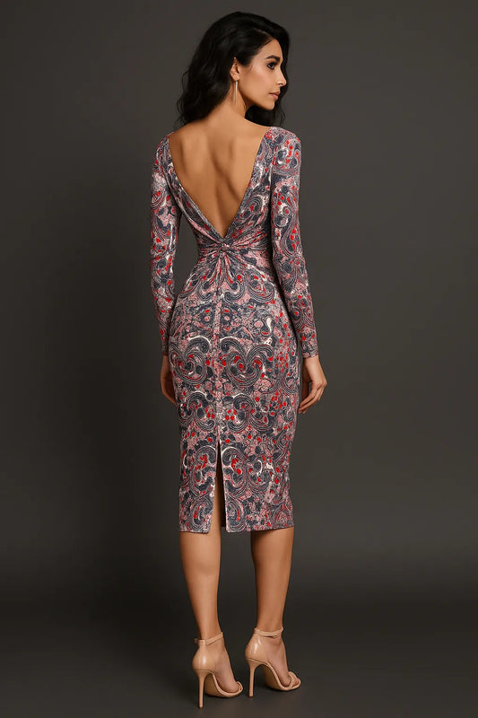 Woman wearing a patterned tango dress with a deep backless design on a dark background
