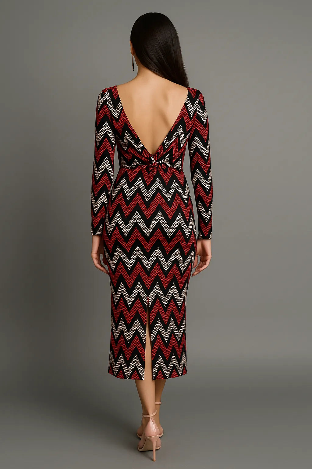 Woman wearing a zigzag patterned tango dress with a backless design on a gray background