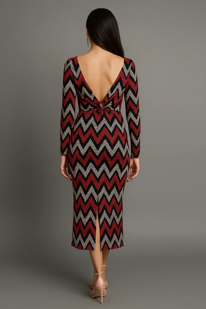 Woman wearing a zigzag patterned tango dress with a backless design on a gray background