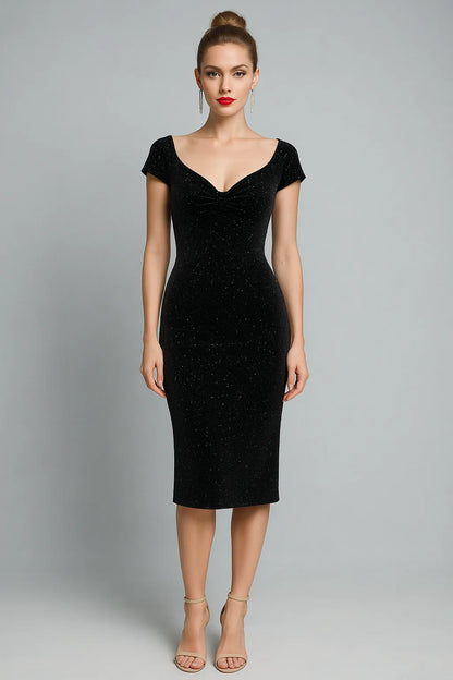 Woman wearing a black tango dress against a gray background