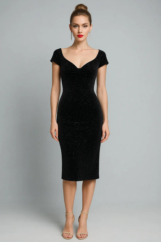 Woman wearing a black tango dress against a gray background