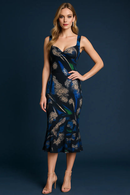 Woman wearing a blue and black patterned tango dress against a dark background