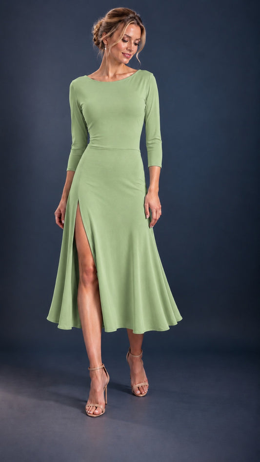 Front view of a pistachio green women’s tango dress with three-quarter sleeves, a flowing skirt and front leg slit, designed for Argentine tango dancing.