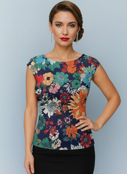 Woman wearing a colorful floral tango top against a light blue background, front view